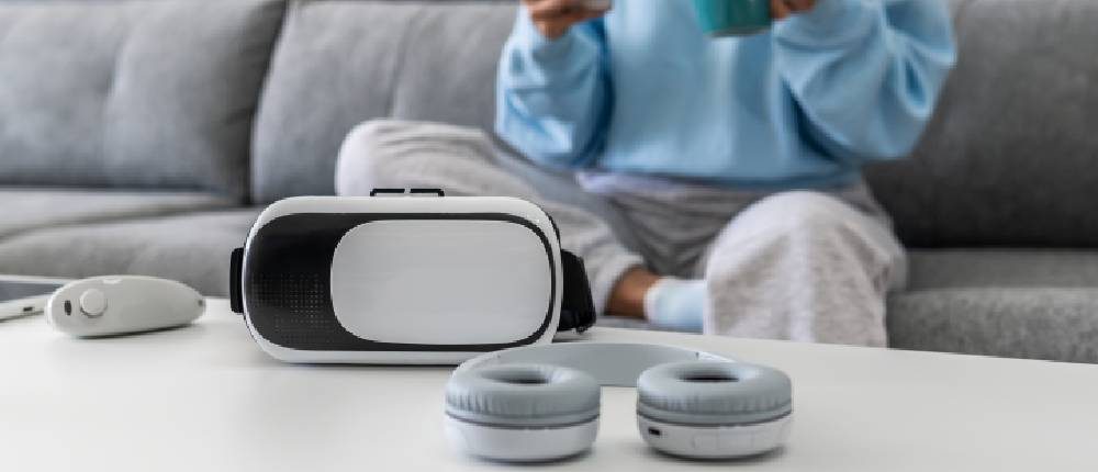 Headphones and a virtual reality headset on a white table